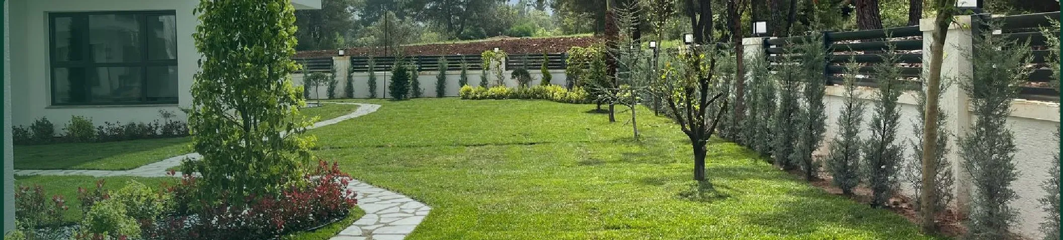 Garden application with planned planting and a natural stone walkway